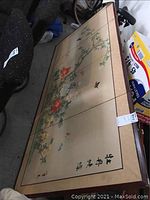 Full view of the floral wall panel art showing flowers, birds, and calligraphy with wood frame.