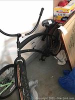 Bike angled from front left showing frame, tires, handlebars, and seat.