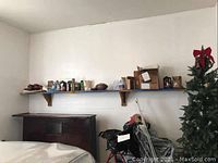 Wide shelf with various cans, plastic bottles, and a brown football placed on it.