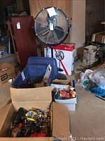 Full view of assembled Utilitech fan, boxes, bins with tools and other items