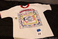 Full view of the rare Phoenixville PA Monopoly game T-shirt with cuff and collar color details.