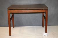Full frontal image of the mid-century modern walnut end table showing rectangular elevated top and wood legs.