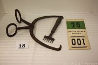 Full view of iron ice tongs with curved gripping ends, ice carver, and two vintage cardboard ice pound order cards showing seller's lot contents.