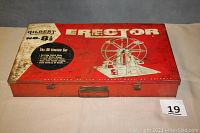 Closed metal red box with Gilbert No. 8-1/2 Erector branding and Ferris wheel illustration