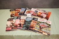 Photo showing all 14 vintage "American Home" magazines fanned out on table with covers visible.