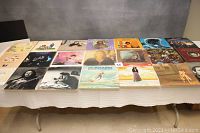Overview of 20 record albums laid out on a table showing various classic rock, soft rock, and folk artists and album covers.