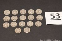 Seventeen silver Washington quarters arranged in rows on black backdrop beside lot number card