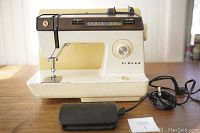 Front view of Singer Contempra 930 sewing machine on table with foot pedal and cords