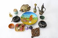 Full lot showing various home decor items including ceramics, metal pot, wooden cross, silver bracelet, and decorative plate