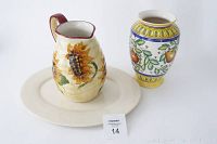 Photo showing sunflower pitcher on top of beige oval platter with ceramic vase beside them