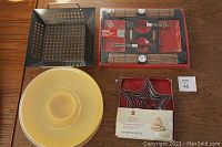 Top view showing all items including sushi set in unopened packaging, appetizer tray, star cookie cutters, and barbecue grill pan