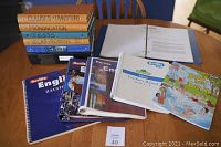 Photo of Berlitz teacher's manuals and colorful children's book, with several binders in background