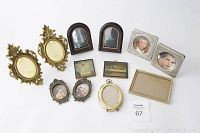 All frames and plaques grouped together on white background, showing variety in vintage frame styles and laminated wood plaques with Jesus and painted people.