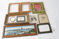 Top view showing variety of empty and framed pieces including panoramic enamel painting and portrait sketches.