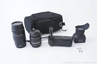Group shot showing bag, two lenses, battery grip and viewfinder loupe