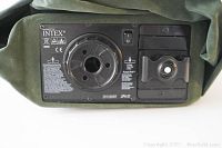 Close-up of the built-in electric pump on the mattress showing the on/off switch, battery compartment, and inflation valve.