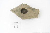 Top and slightly angled view of the stone Ikebana flower holder with a circular metal spike ring center and natural marbled surface.