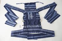 Blue and gray striped Mei Tai style baby carrier laid flat, showing padded shoulder straps, wide waist belt, rectangular body panel with head cover above, and back pocket.