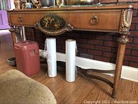 Full view of antique wooden console table showing front panel, legs, and countertop with minor chips and stains.