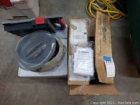 Box with Medichoice branding containing enema bags along with instructions next to the heater