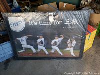 Framed poster showing four sequential pitching images of Dodgers player Hong-Chi Kuo with bilingual text and Dodgers logo.