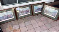 Four framed fox hunt themed wall art pieces arranged on the ground near a window, showing their overall size and framing style.