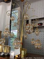 Photo showing the full music box with its hanging crystal eggs and part of the surroundings