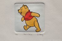 Close-up of the hand painted Winnie the Pooh etching showing the character, numbering 4/500, and signatures by Sowa and Reiser with Disney copyright