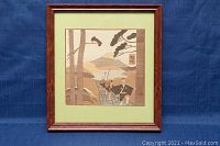 Front view of framed Japanese inlaid wooden artwork depicting Mount Fuji and a group of traditionally dressed figures on a pathway, mounted on a green mat and in a reddish wood frame.