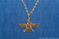 Close-up of the detailed Birdman pendant showing front design with wings, head, and body featuring intricate etching.