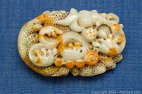 Front view of carved jade showing fish and coral detail