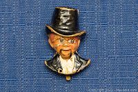 Front view of the Charlie McCarthy pin showing the character's painted face, black top hat, and tuxedo jacket.