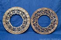 Two cast iron stovepipe collars placed side by side on a blue background, showing overall view and size relative to each other.