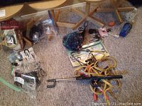 Overview of all items on carpet showing booster cables and other accessories