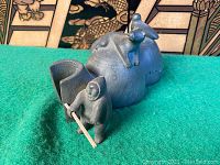 Front three-quarter view showing igloo entrance and seated Inuit figure holding paddle