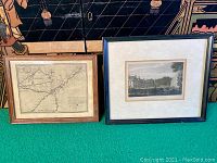 Two framed items side by side on green surface: old map print on left, historical engraving on right.