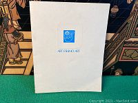 White folio with a blue Eskimo art logo on the front cover against a green background