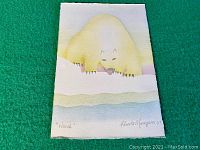 Full front view of the watercolor painting showing the polar bear figure on textured paper with light yellow and white hues.
