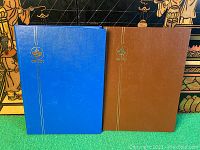 Blue and brown stockbooks with gold emblem on cover