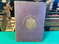 Front cover of purple cloth hardcover bearing gilt-stamped title, crest and date