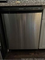 Front exterior view of stainless steel Frigidaire dishwasher with black control panel