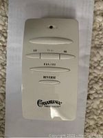 Remote control for Casablanca Versa-Touch ceiling fan with labeled buttons for speed settings, fan off, and reverse.
