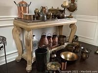 Full view of the table with various decorative items displayed on and around it to show size and style.