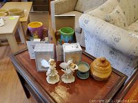 Full lot viewed from above on wooden table, includes mugs, figurines, pot and wooden bowl