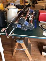 Photo showing drywall stilts folded and resting along with the two-step ladder.