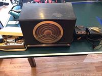 Photo of large RCA Victor vintage radio with circular front speaker grille and visible wear on top surface