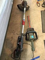 Craftsman electric weedwhacker with visible cutting guard and black and red accents on silver shaft on concrete floor.