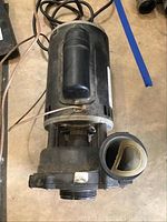 Front view of the GE Commercial Motors hot tub pump showing motor and pump housing with wiring seen.