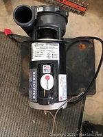 Full view of US Motors Executive 5X hot tub pump showing label with model number R63MWENA-4727 and power cord.