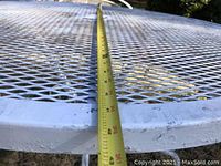 Close-up of mesh table top with tape measure showing approximately 42 inches diameter